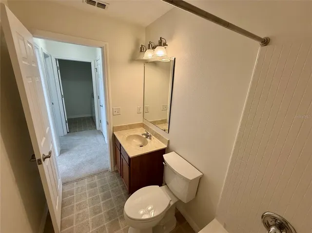 a white toilet sitting next to a bathroom sink