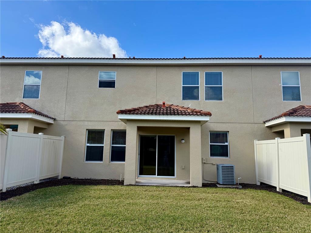 2090 Water Tupelo Way Ocoee, FL 34761 - Photo 30 of 43 a front view of a house with a garden