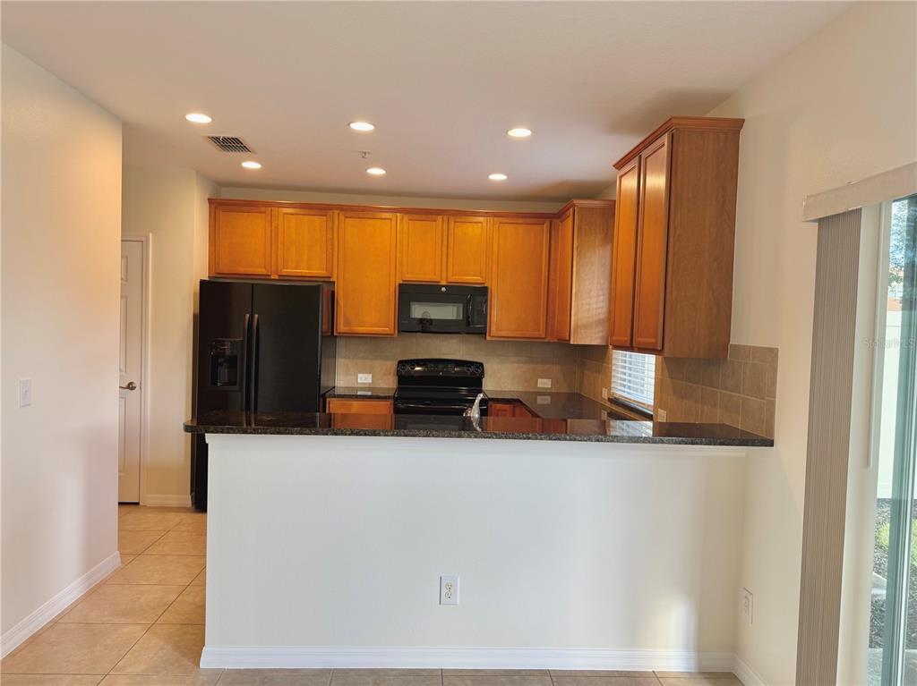 2090 Water Tupelo Way Ocoee, FL 34761 - Photo 3 of 43 a kitchen with stainless steel appliances a refrigerator and a stove
