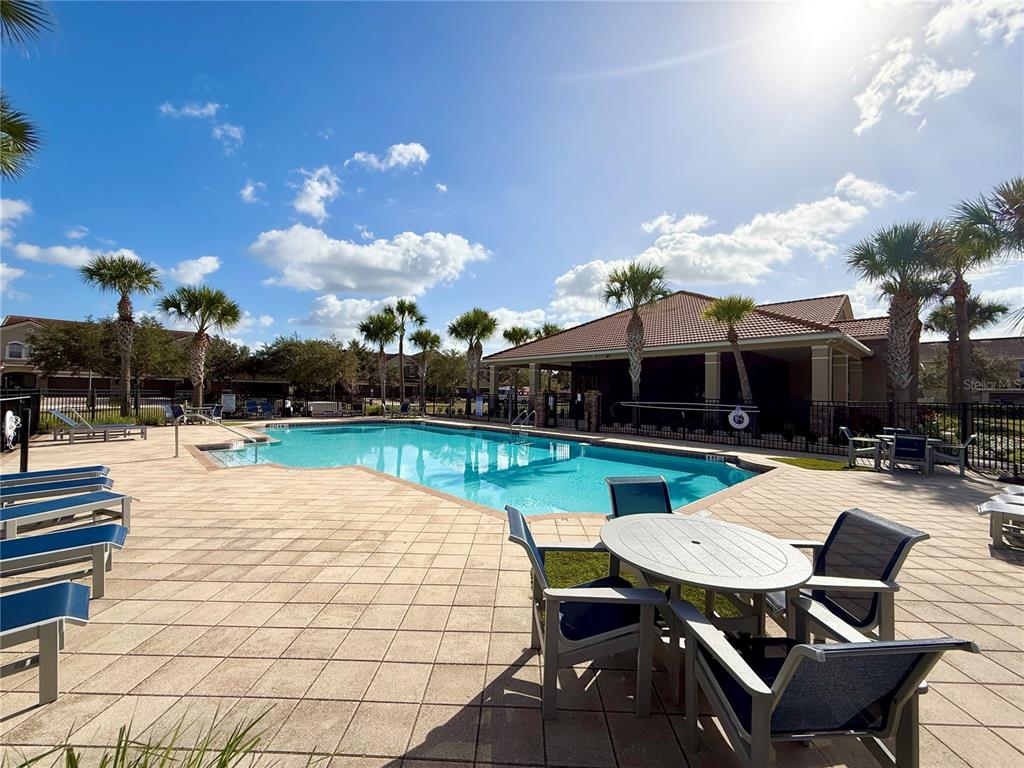 2090 Water Tupelo Way Ocoee, FL 34761 - Photo 34 of 43 a view of a patio with dining table and chairs with a swimming pool