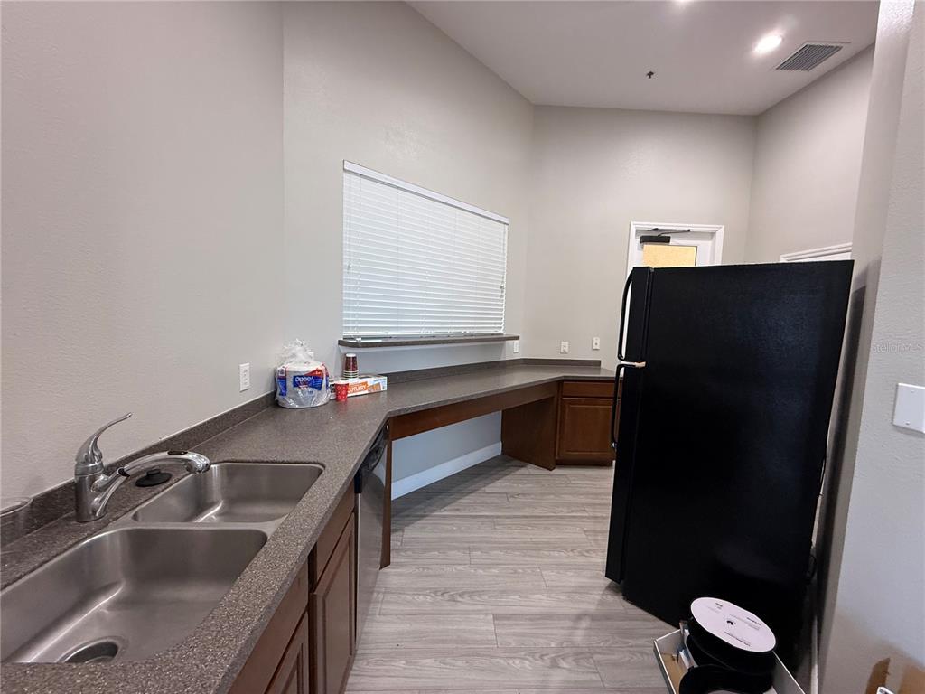 2090 Water Tupelo Way Ocoee, FL 34761 - Photo 41 of 43 a kitchen with a sink and a refrigerator