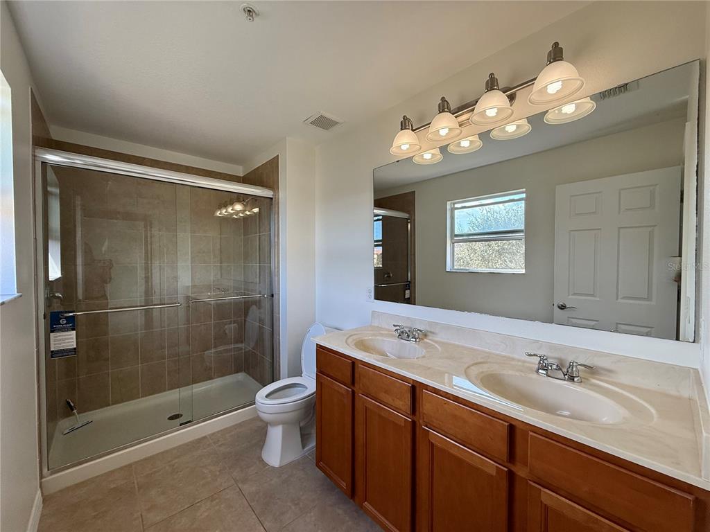 2090 Water Tupelo Way Ocoee, FL 34761 - Photo 7 of 43 a bathroom with a sink a toilet and shower
