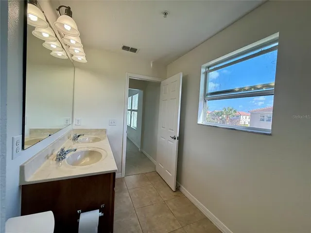 a bathroom with a sink a mirror and a toilet