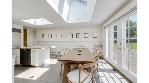 a view of a hallway with furniture and entryway