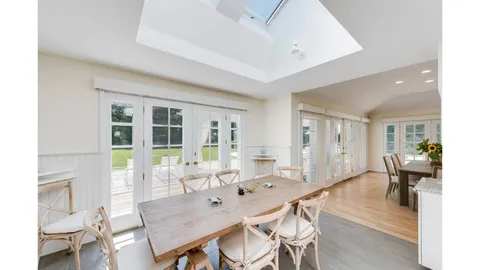 a dining room with furniture and window