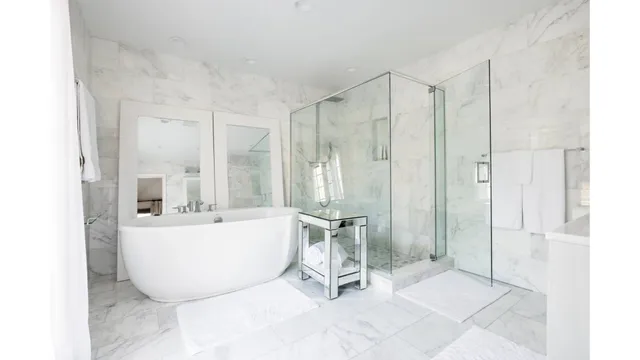 a view of a bathroom with tub mirror and windows