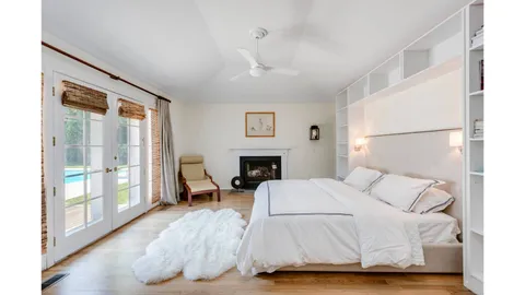 a bedroom with a large bed and a large window