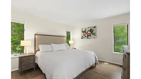 a bedroom with a large bed and a large window