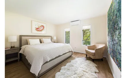 a bedroom with a bed and a couch