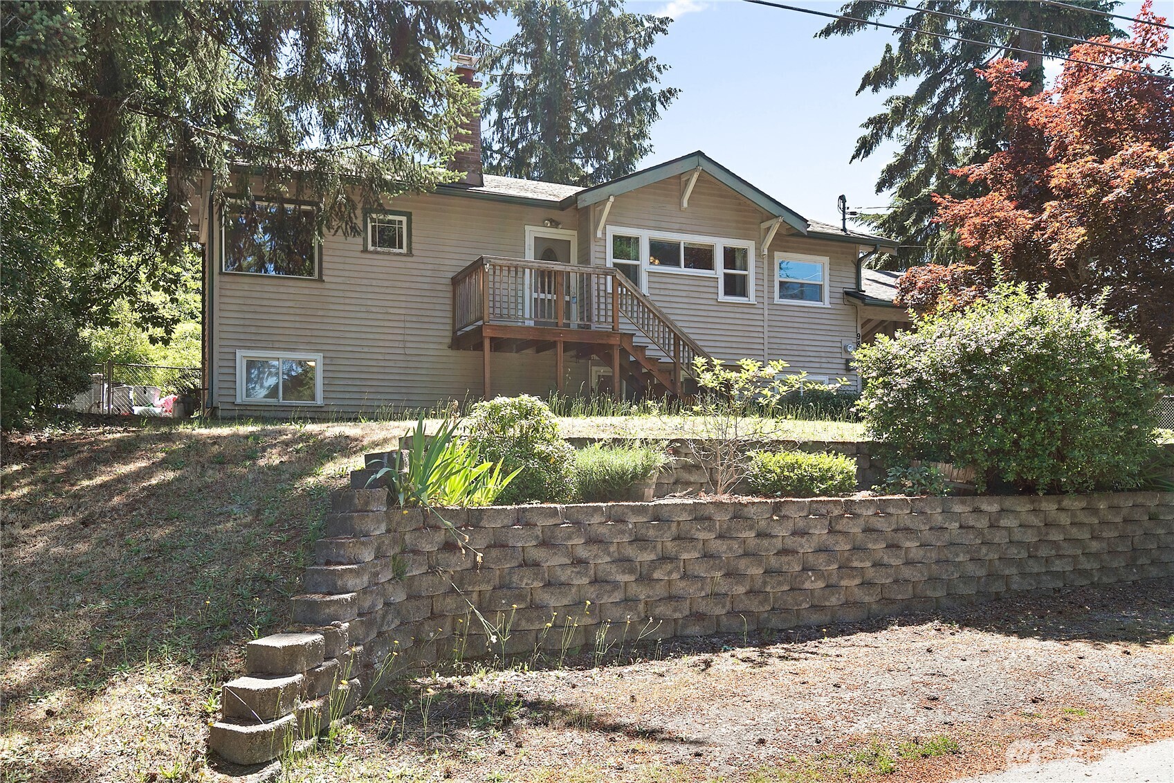 9880 Fredrickson Road Northwest Bremerton, WA 98311 - Photo 1 of 28 a front view of a house with a yard and garage