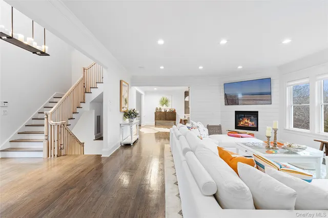 a living room with furniture fireplace and wooden floor