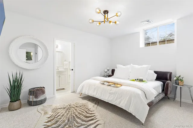 a bedroom with a bed and a potted plant