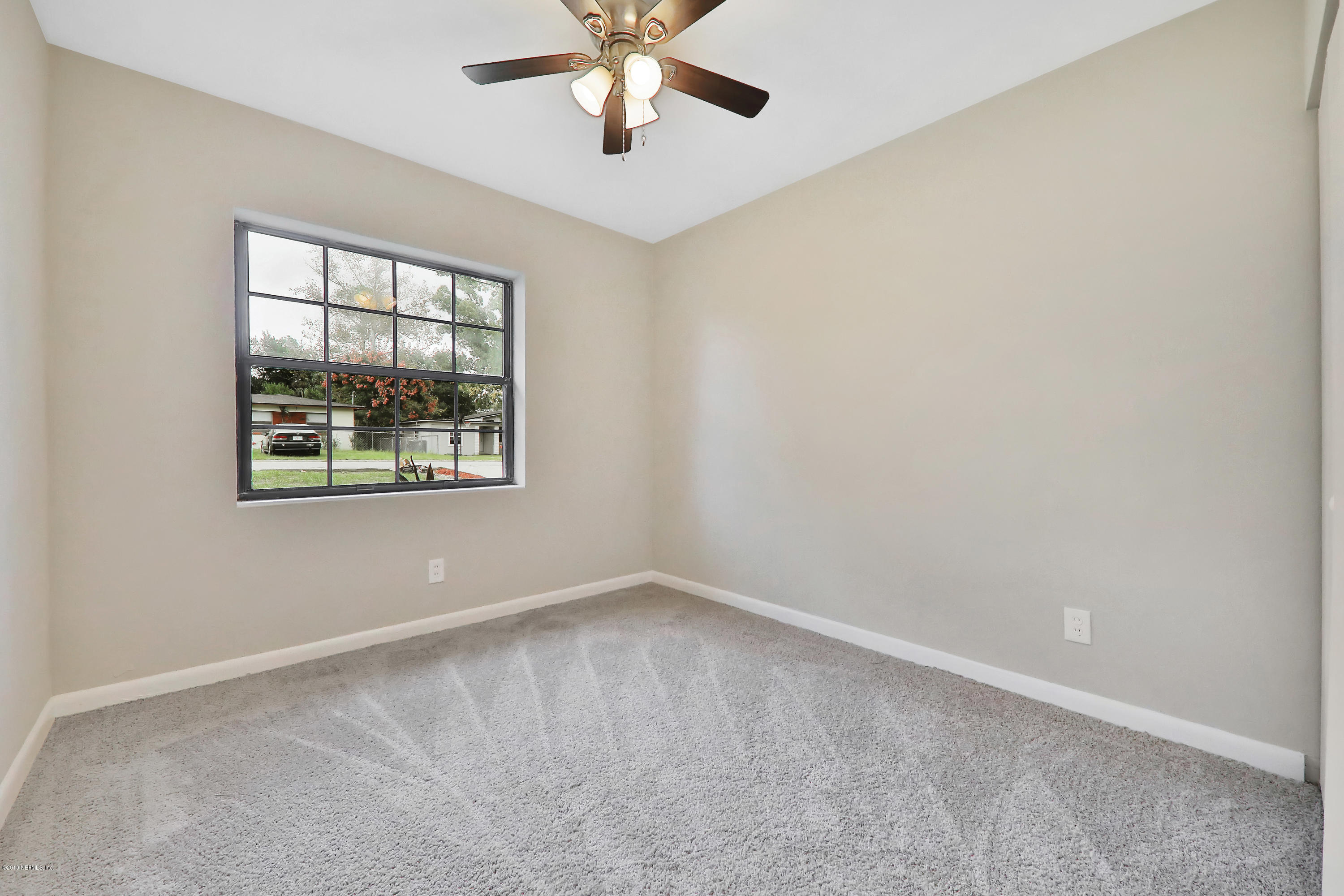 10512 Stone Road Jacksonville, FL 32246 - Photo 11 of 22 an empty room with windows and fan