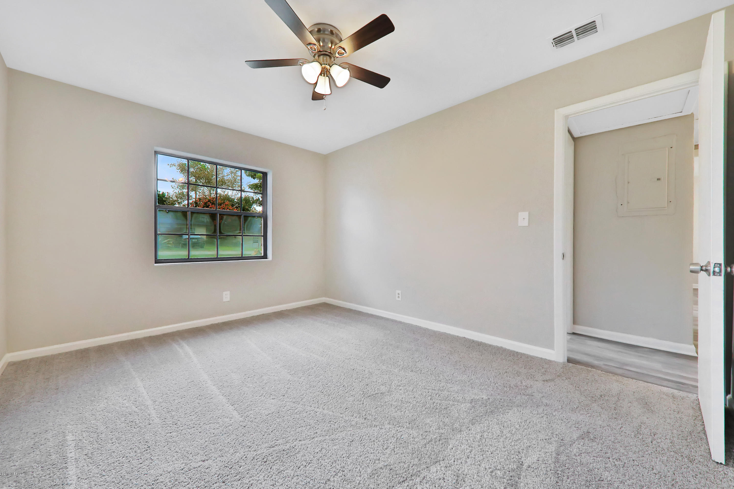 10512 Stone Road Jacksonville, FL 32246 - Photo 13 of 22 an empty room with windows and ceiling fan