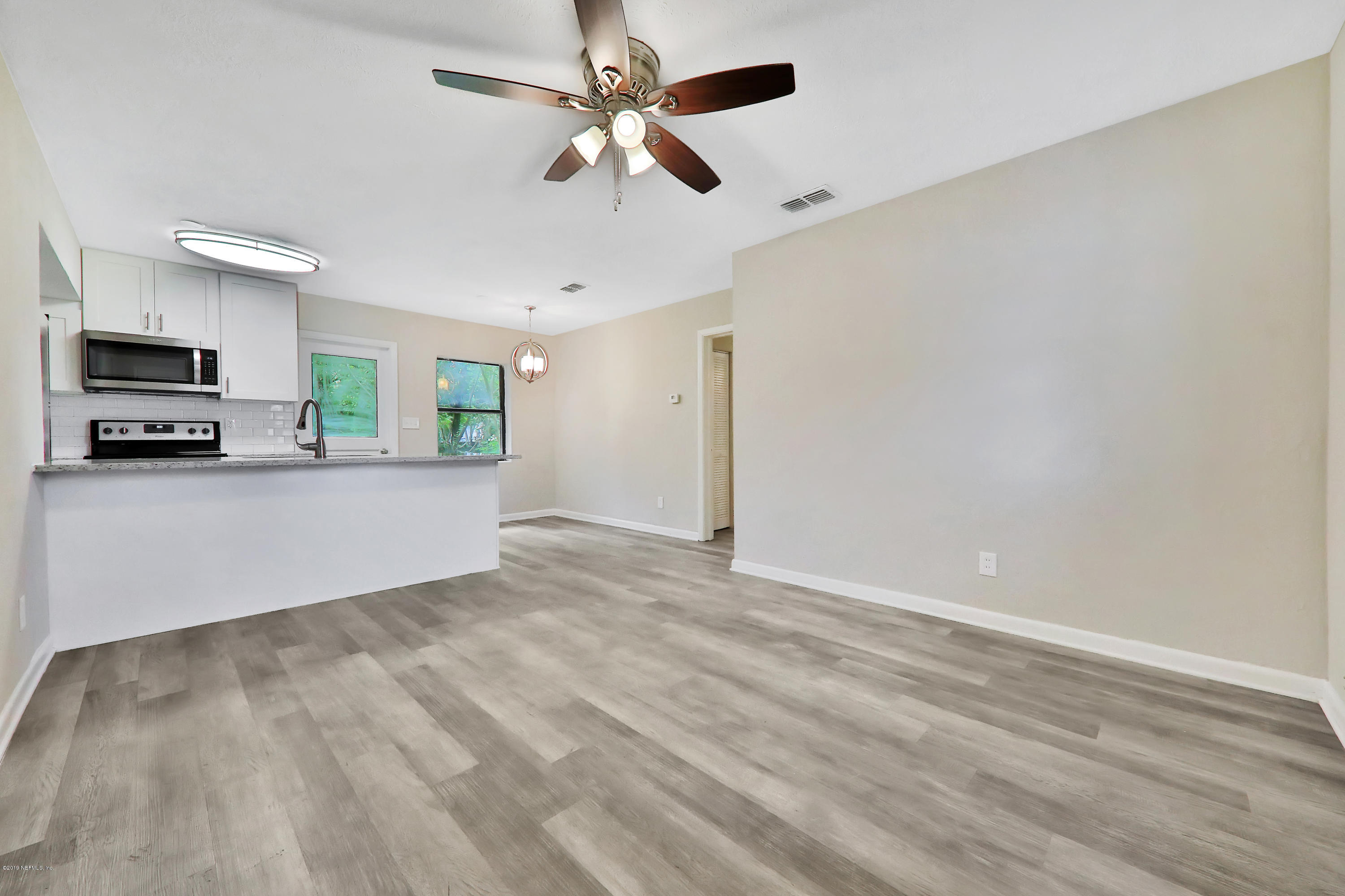 10512 Stone Road Jacksonville, FL 32246 - Photo 2 of 22 a view of a livingroom with a kitchen and a stove top oven
