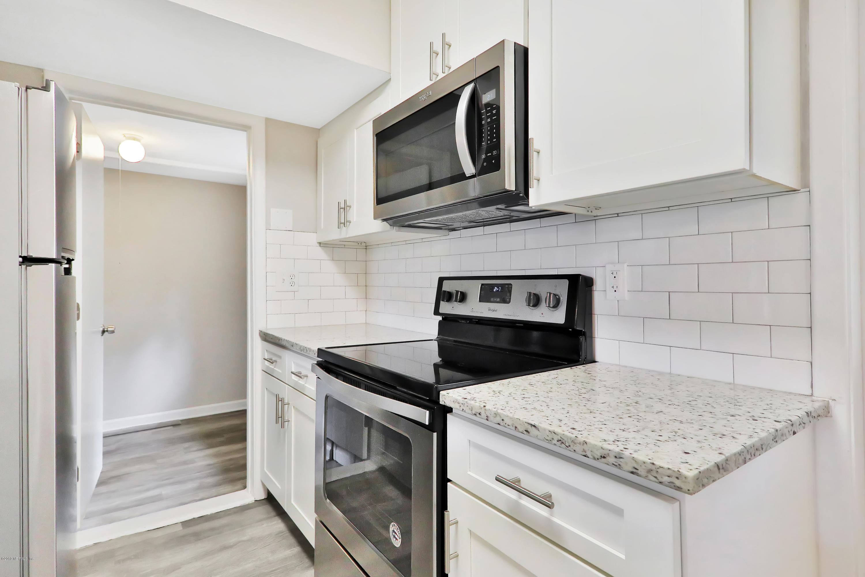 10512 Stone Road Jacksonville, FL 32246 - Photo 7 of 22 a kitchen with granite countertop cabinets stainless steel appliances and wooden floor
