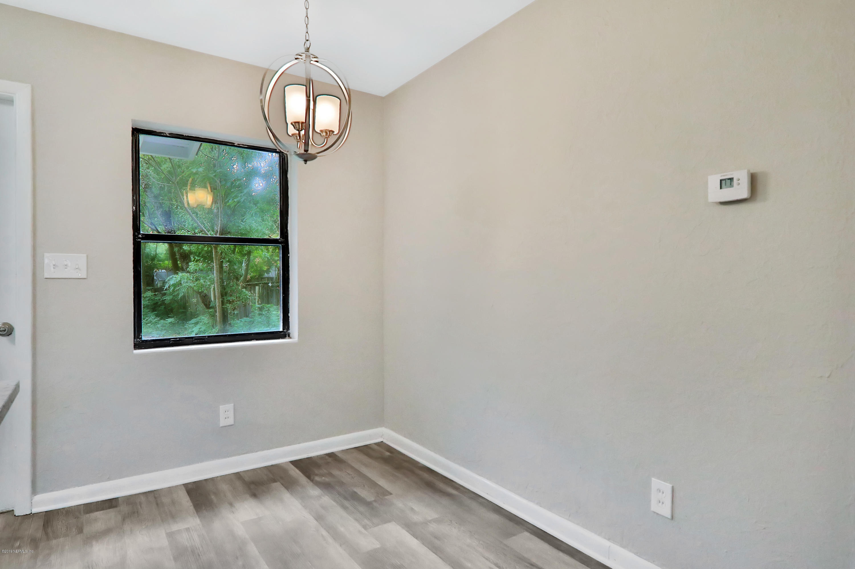 10512 Stone Road Jacksonville, FL 32246 - Photo 9 of 22 a view of empty room with wooden floor and fan
