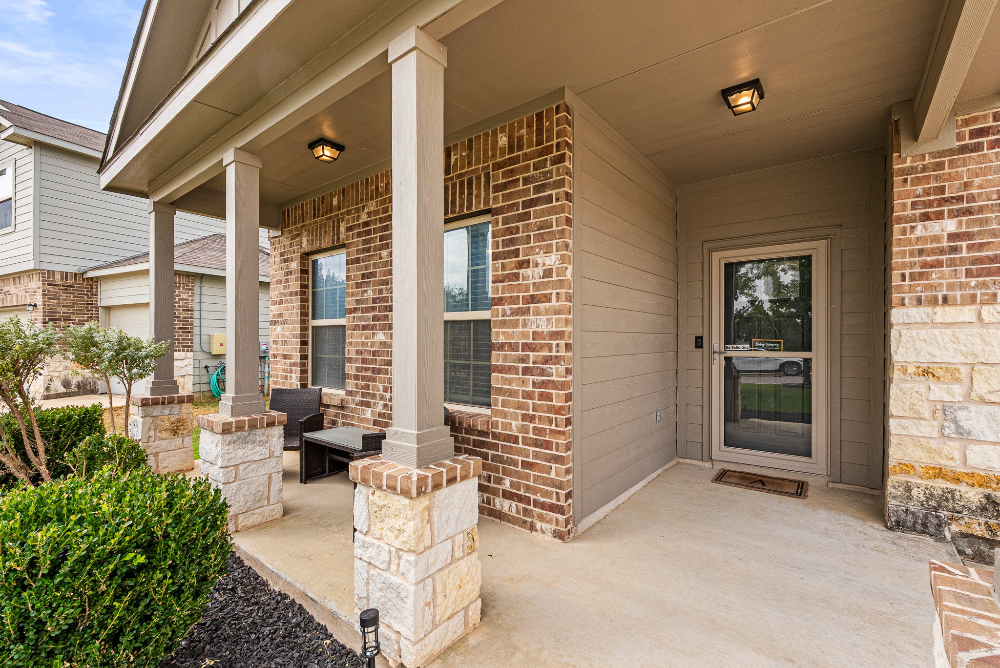136 Copper Lane Kyle, TX 78640 - Photo 4 of 33 Doorway to property with covered porch and brick siding