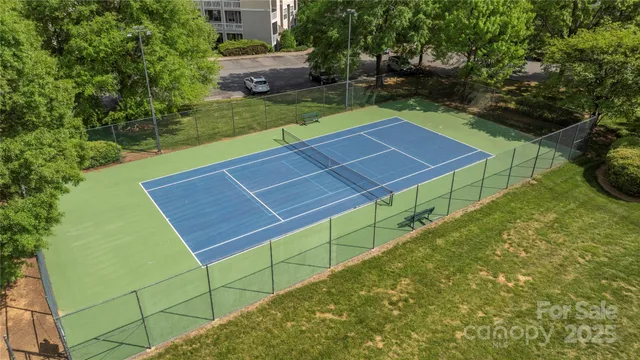 a view of a backyard with table and chairs with wooden fence and plants
