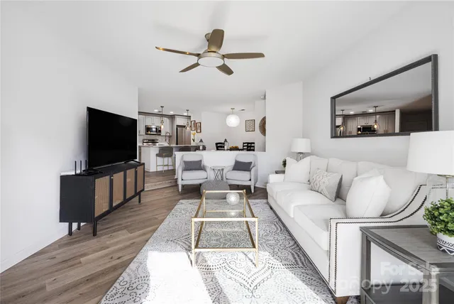 a living room with couches and a flat screen tv