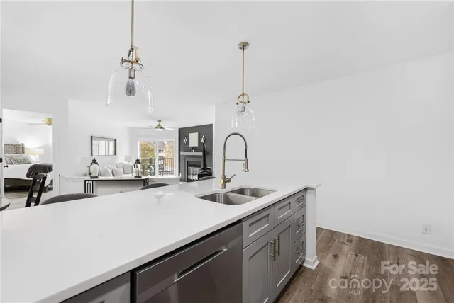 a kitchen with a sink a counter and chairs