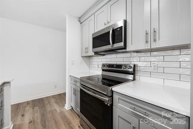 a kitchen with a stove and a microwave