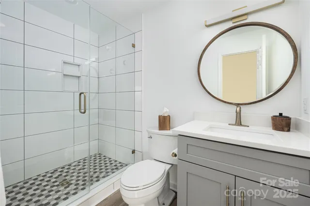 a bathroom with a sink a toilet and a mirror