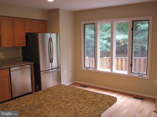 7285 Olde Lantern Way Springfield, VA 22152 - Photo 3 of 7 a kitchen with a refrigerator and window