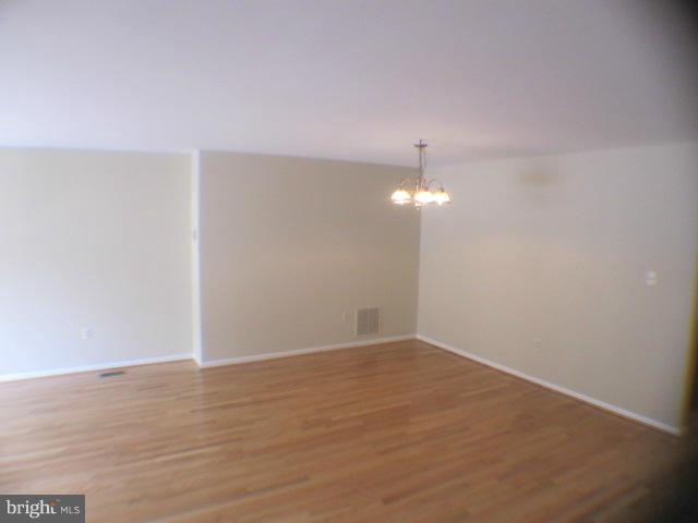 7285 Olde Lantern Way Springfield, VA 22152 - Photo 6 of 7 a view of an empty room with wooden floor