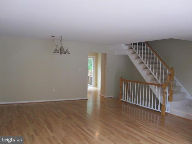 7285 Olde Lantern Way Springfield, VA 22152 - Photo 7 of 7 an empty room with wooden floor and windows