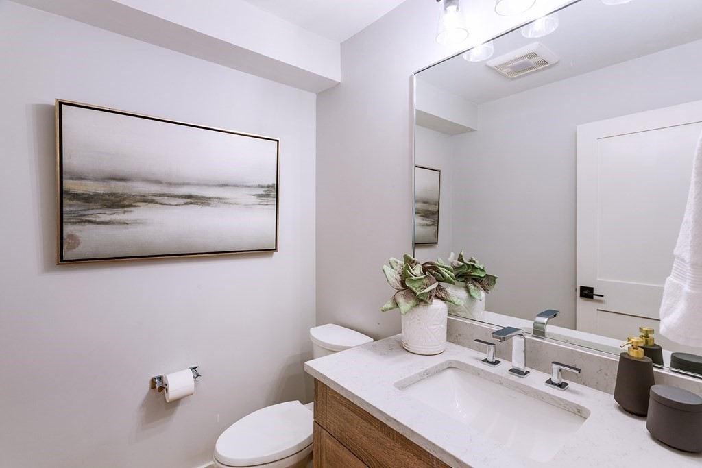 165 Atlantic Road, Unit 1 Gloucester, MA 01930 - Photo 11 of 17 a bathroom with a sink mirror and toilet