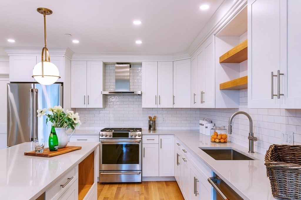 165 Atlantic Road, Unit 1 Gloucester, MA 01930 - Photo 7 of 17 a kitchen with stainless steel appliances granite countertop a sink a stove and a wooden floors