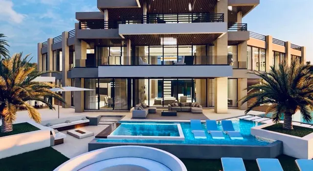 a view of a patio with couches table and chairs potted plants and palm tree