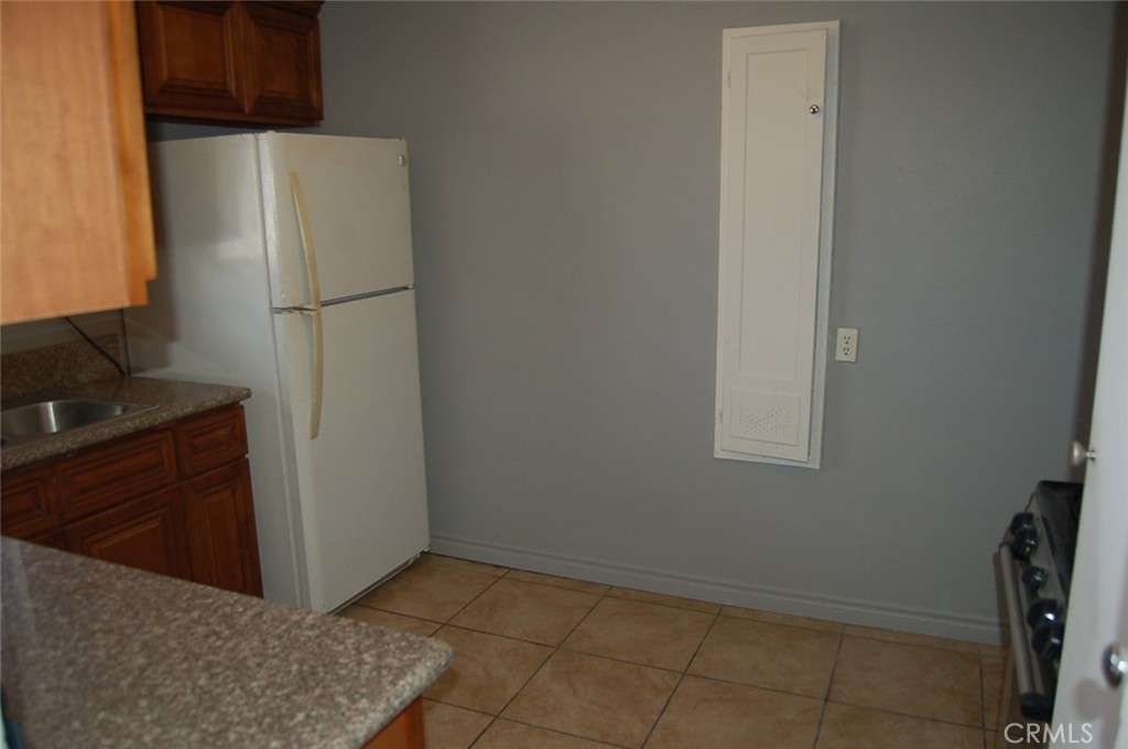422 West Palm Street, Unit 424 1/2D Compton, CA 90220 - Photo 13 of 17 a view of a kitchen with refrigerator and cabinet