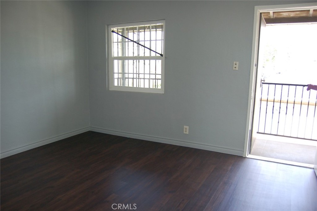 422 West Palm Street, Unit 424 1/2D Compton, CA 90220 - Photo 6 of 17 an empty room with wooden floor and windows