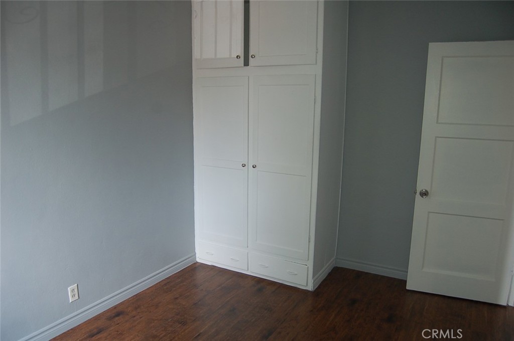 422 West Palm Street, Unit 424 1/2D Compton, CA 90220 - Photo 8 of 17 an empty room with wooden floor