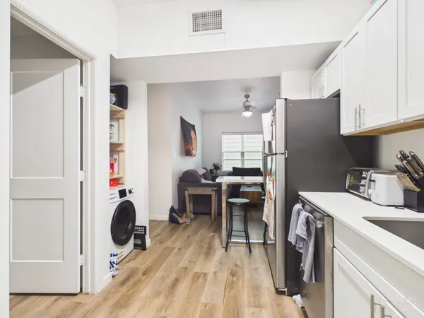 a kitchen with refrigerator and table