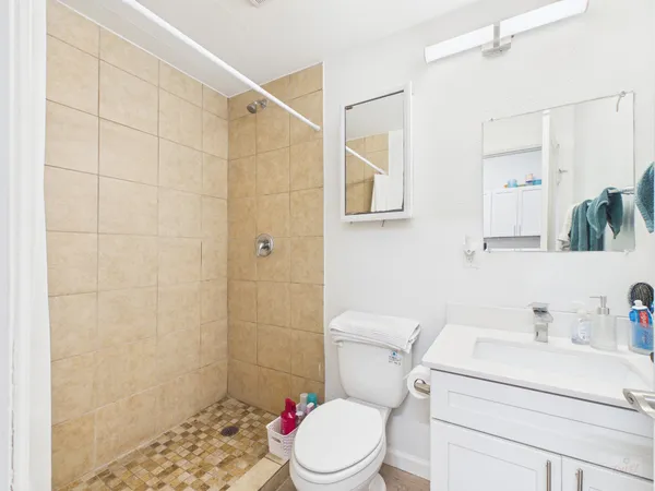 a white toilet sitting next to a bathroom sink