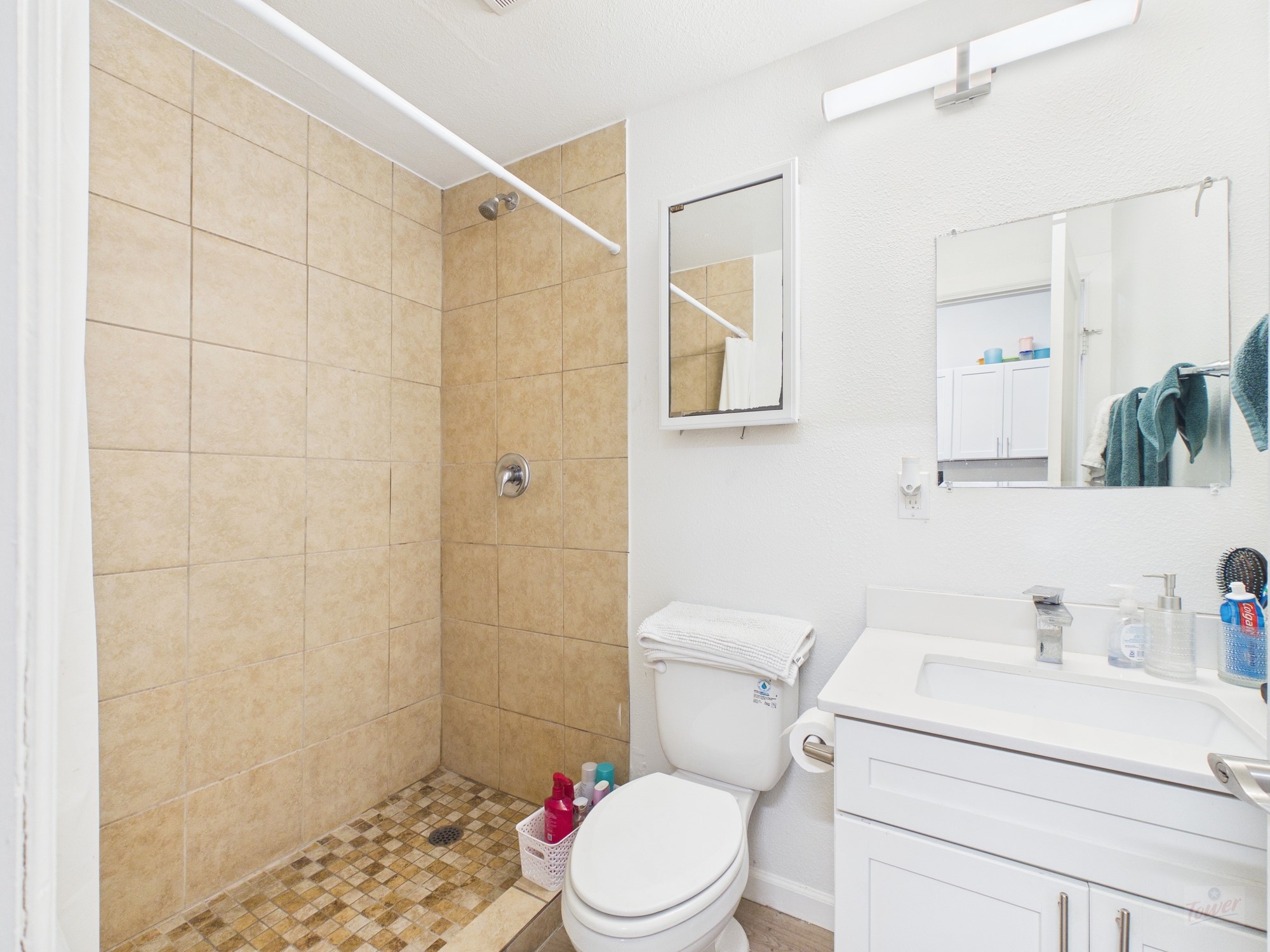 911 West 22nd Street, Unit 403 Austin, TX 78705 - Photo 3 of 13 a white toilet sitting next to a bathroom sink