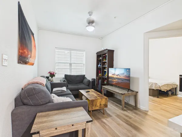 a living room with furniture and a wooden floor