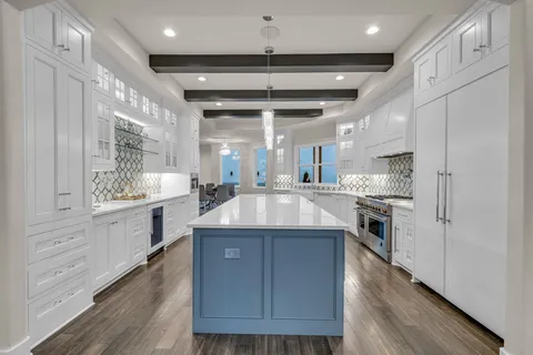 a bedroom with a large bed and a ceiling fan