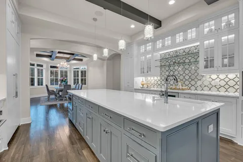 a kitchen with stainless steel appliances granite countertop a sink and a stove