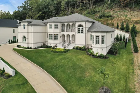 a front view of a house with a garden