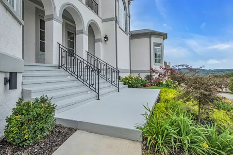a view of a pathway of a building with flower plants