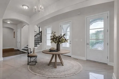 a living room with furniture and a chandelier