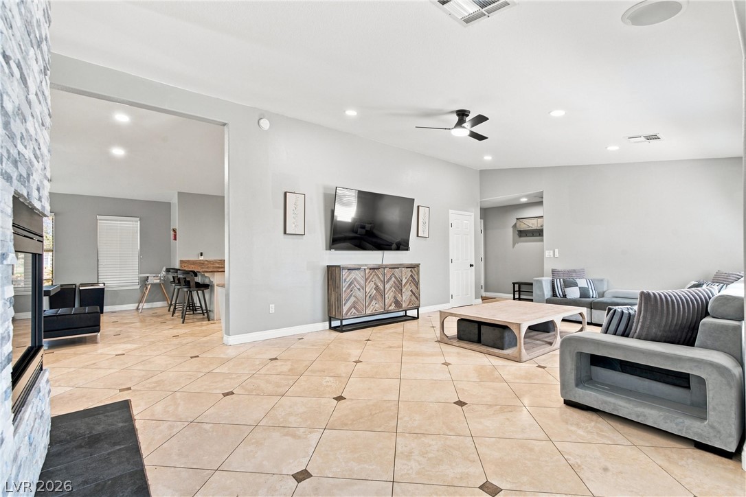 7744 Rancho Destino Road Las Vegas, NV 89123 - Photo 47 of 48 An open floor plan connects the living area with tiled floors and recessed lighting.