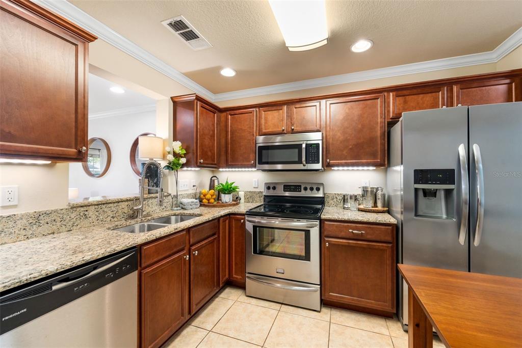 4639 Southwest 48th Drive, Unit 151 Gainesville, FL 32608 - Photo 15 of 26 a kitchen with stainless steel appliances granite countertop a stove top oven a sink and a granite counter tops