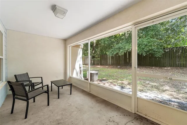 a view of a room with a large window and dining table