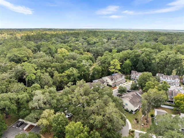 an aerial view of a houses with a yard