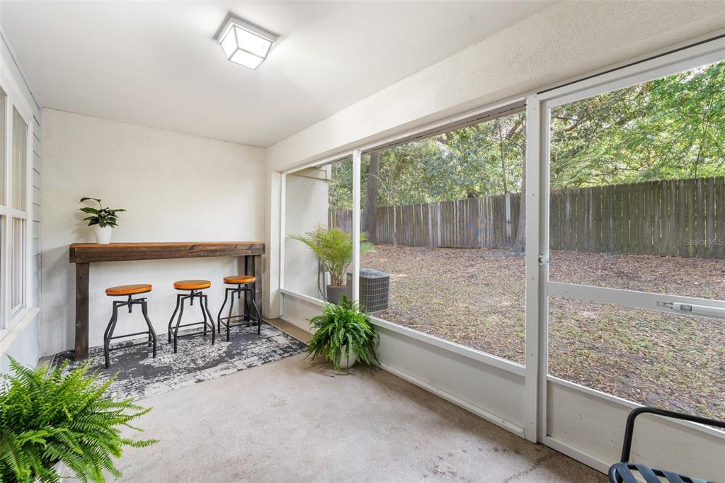 4639 Southwest 48th Drive, Unit 151 Gainesville, FL 32608 - Photo 20 of 26 a porch with a table and chairs